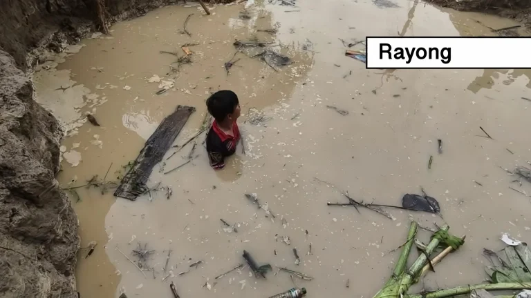Jonge fabrieksmedewerker kon ternauwernood gered worden nadat overstromingswater hem met motor en al in Oost-Thailand meesleurde.