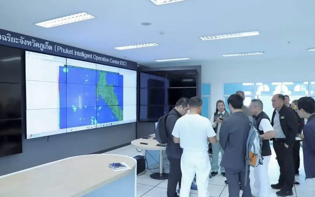 Officials discuss a Phuket tourism safety system in an operations center.